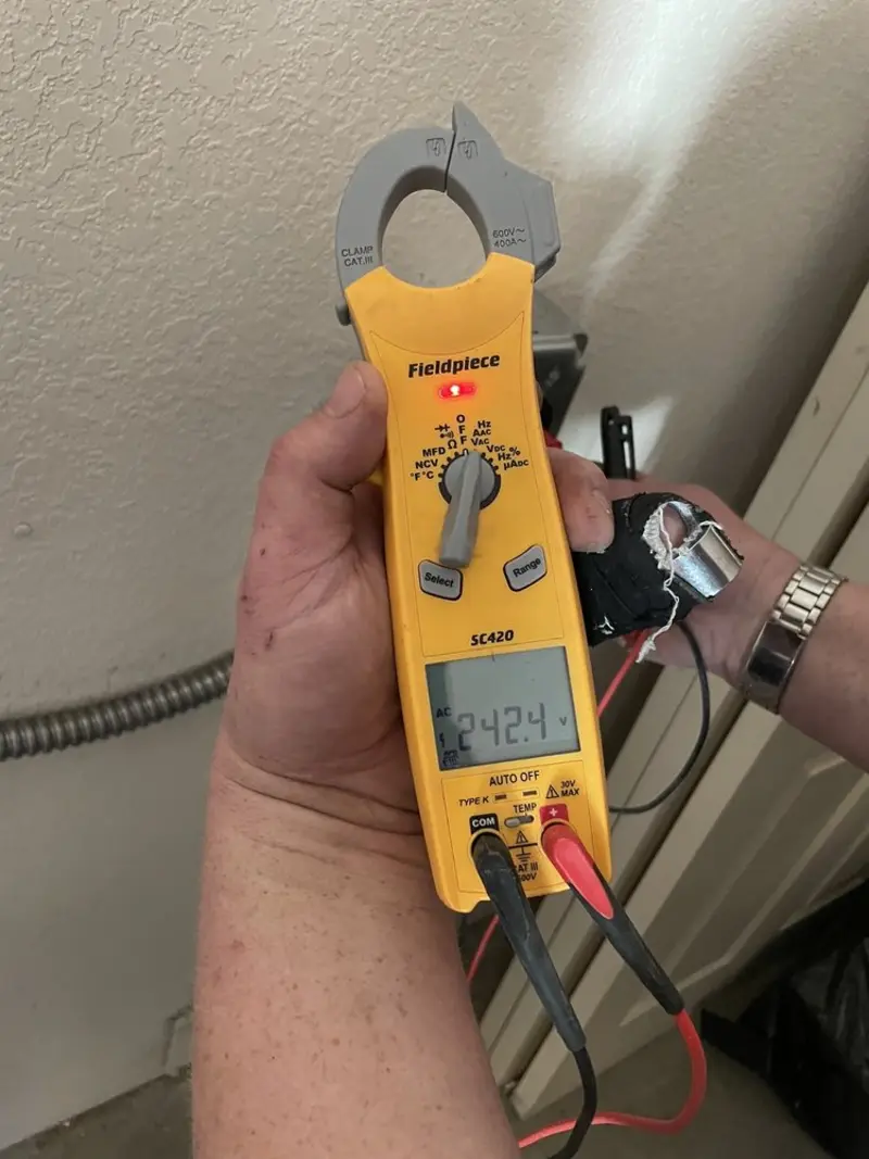 Voltage testing with clamp meter during Electrical Installation Services in Barry